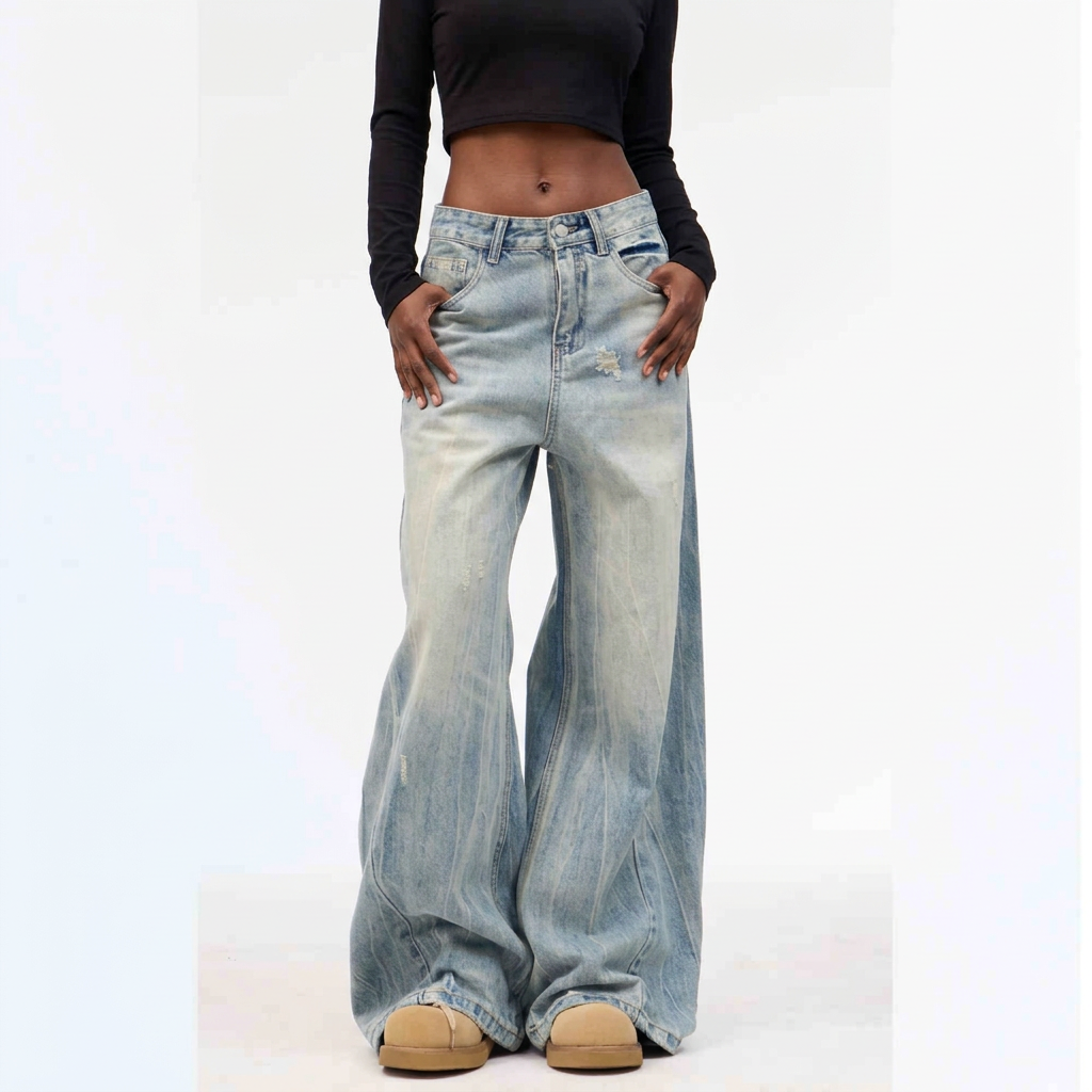 Washed blue wide-leg jeans shown on a Black model against a white background