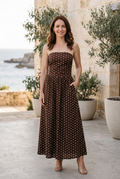 Brunette model in coffee-brown Amelie strapless polka-dot maxi dress