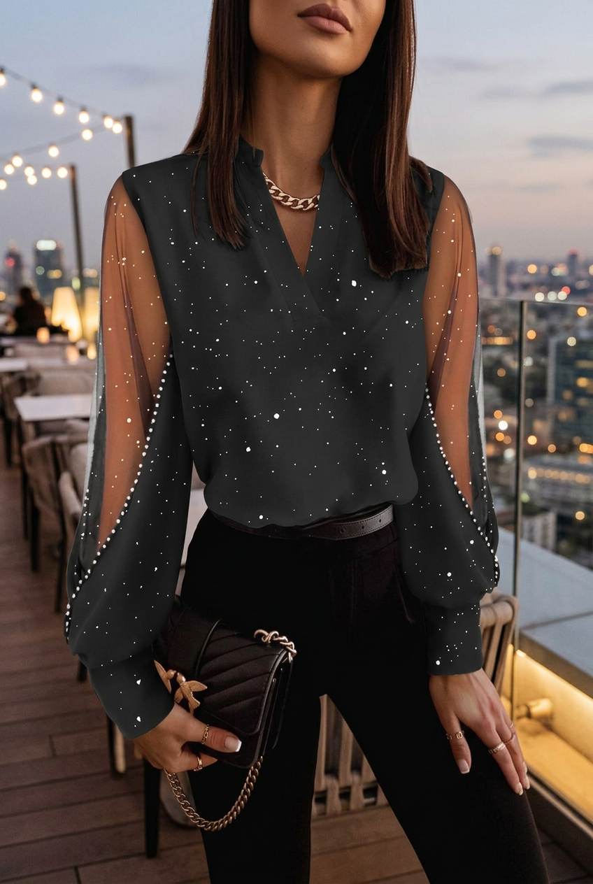 Aurelie black sparkle blouse in a rooftop evening setting