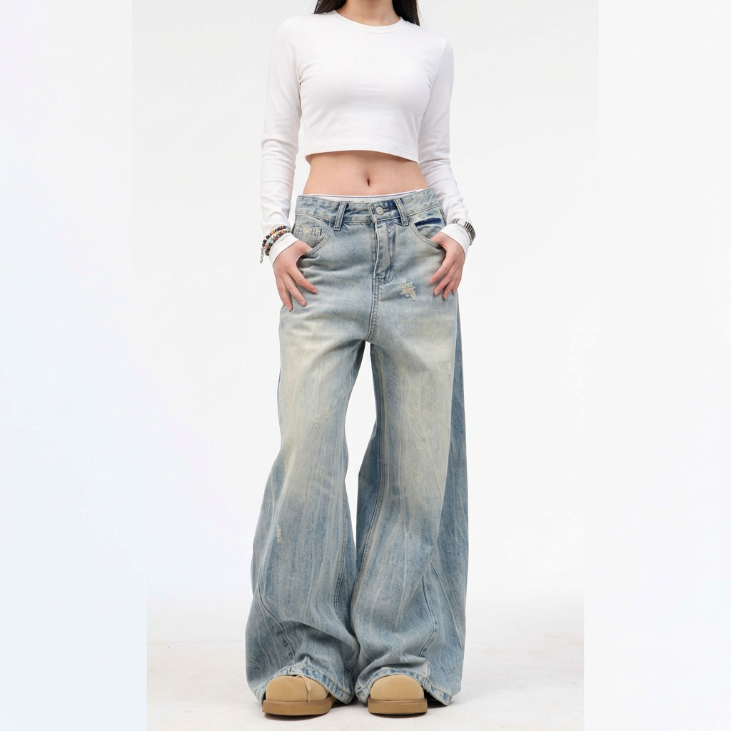 Washed blue wide-leg jeans and white long-sleeve cropped top against a white background